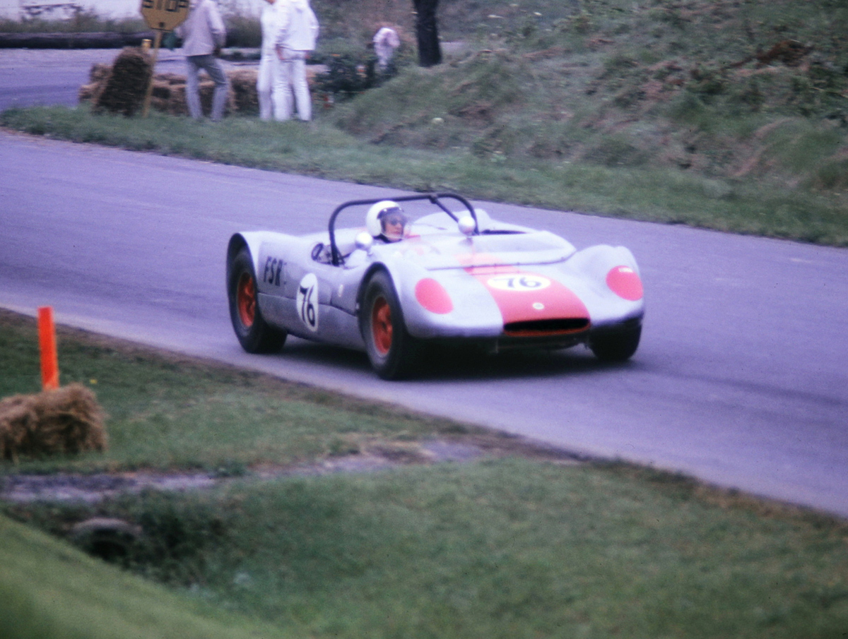 Judy alone in the Lotus 23, looking up the hill to the L turn onto the airport.
