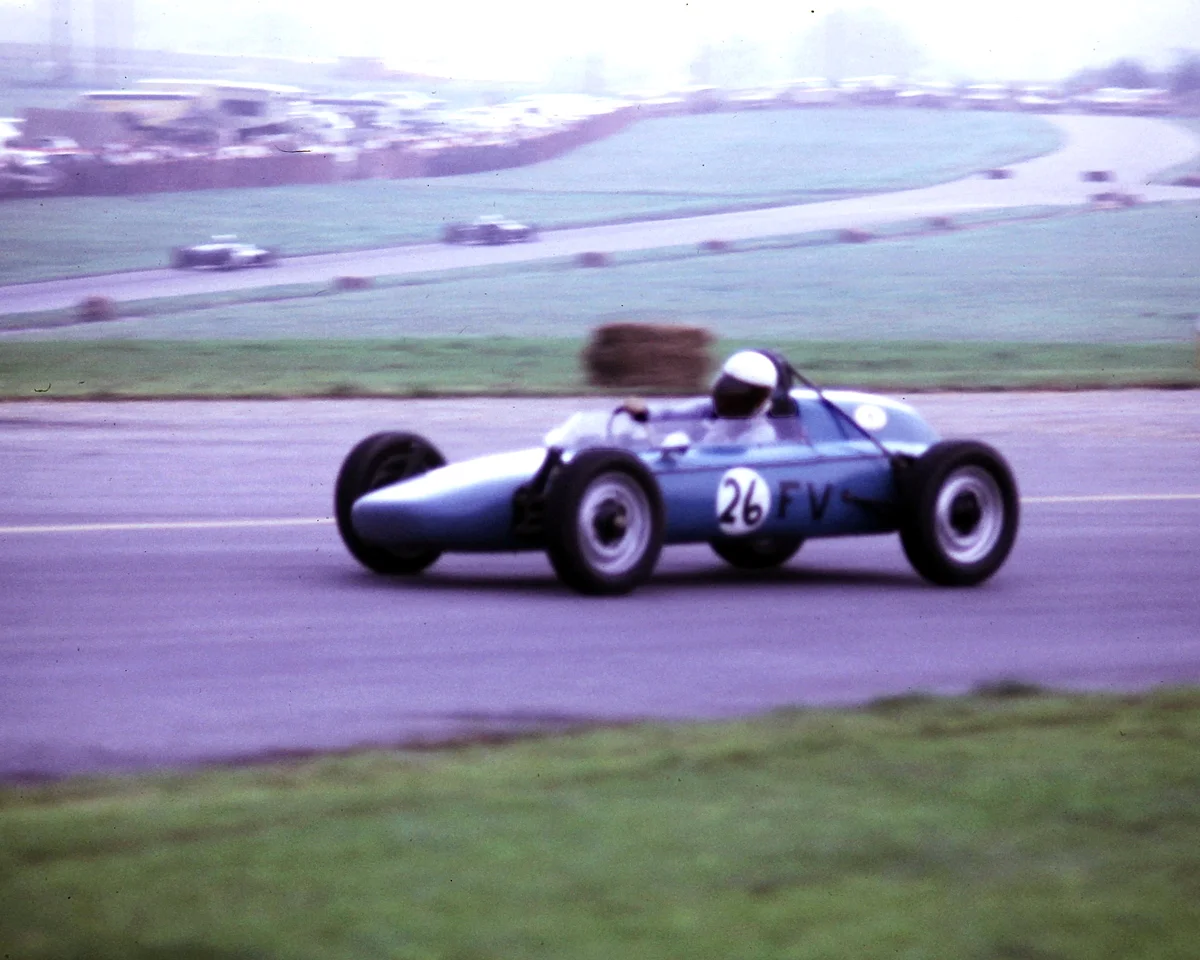 This #24 Formula Vee is not in the entry, but the driver is working hard. You can clearly see cars heading up the hill in the distance.