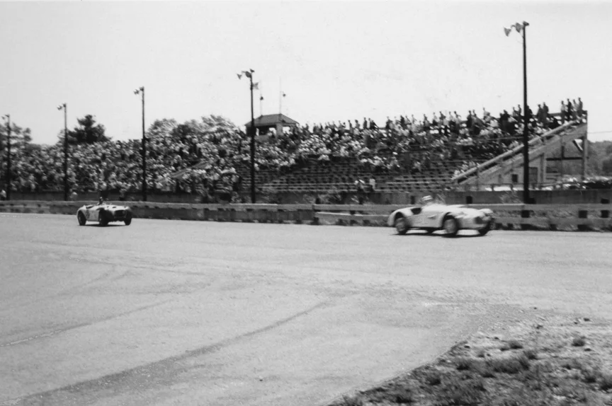 Preston Gray's Allard leads Paul Timmon's Jag Special past the grandstand. Timmons would finish 2d and Gray 4th in the Unrestricted race.