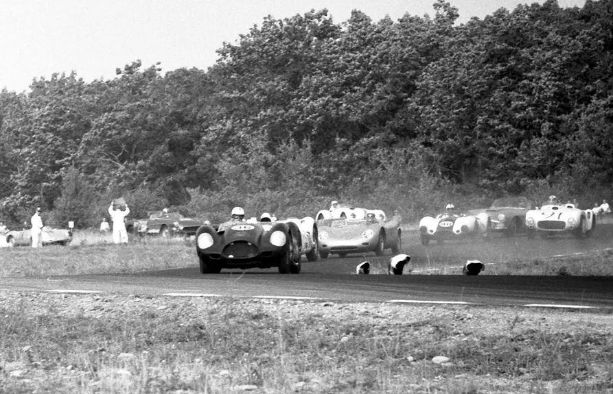 Freddy Windridge leads the first lap into the chicane in the scary KelsoChev, but not for long. Holbert challenges Crawford, the Sadler Special and #91 Hi-Tork Ferrari follow.
