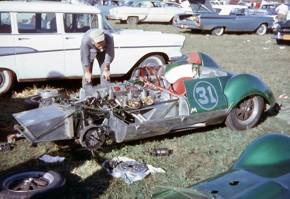 BARC memeber Chuck Dietrich’s emerald Elva Mk IV is torn apart. They got it fixed and Dietrich was 2nd behind the Lola. Drum brakes in front and the starter laying in the grass.