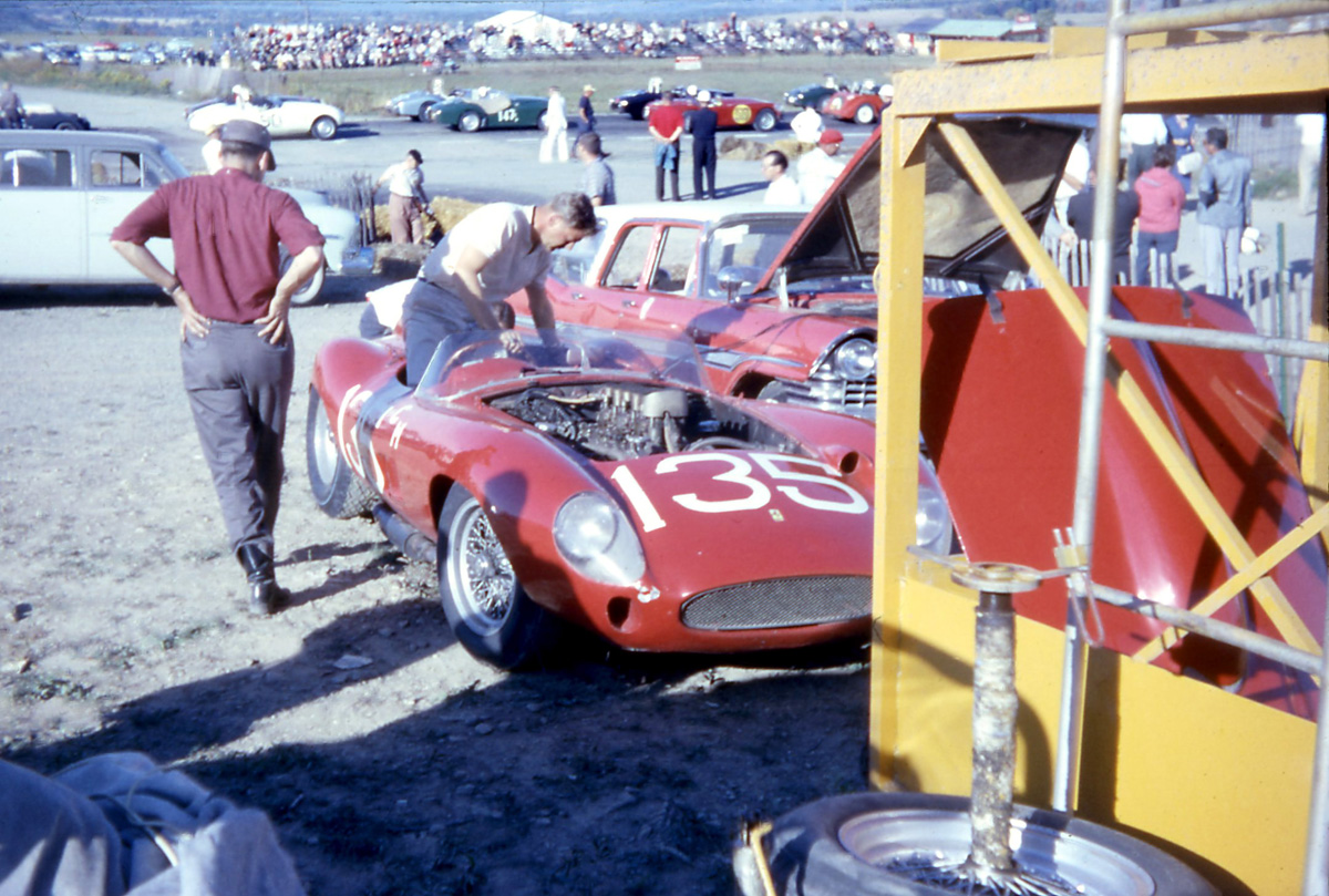Ed Gelder’s Ferrari Monza gets a jump start from his Dodge Station Wagon. Wagons were the popular tow vehicle of the day. In back, the D & E production race forms on the start grid.