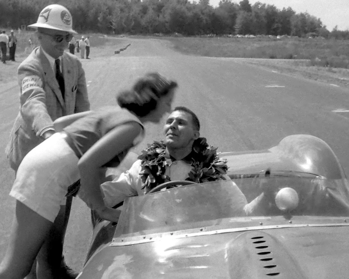 Cameron Argetsinger congratulates Bill Sadler’s wife as he receives a victory kiss before the checkered flag lap.