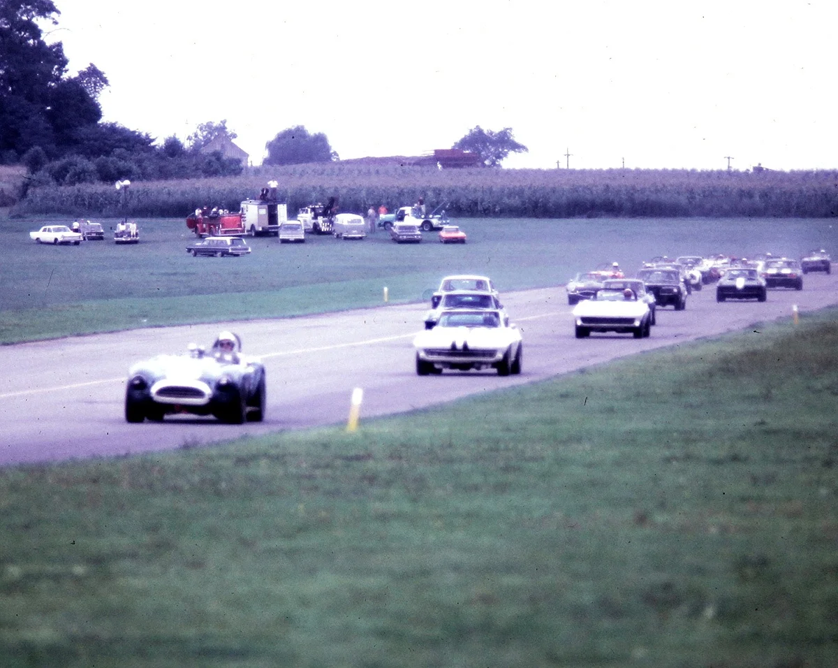 F.G.Fisher’s Cobra leads the pack at the start of the big bore production race.