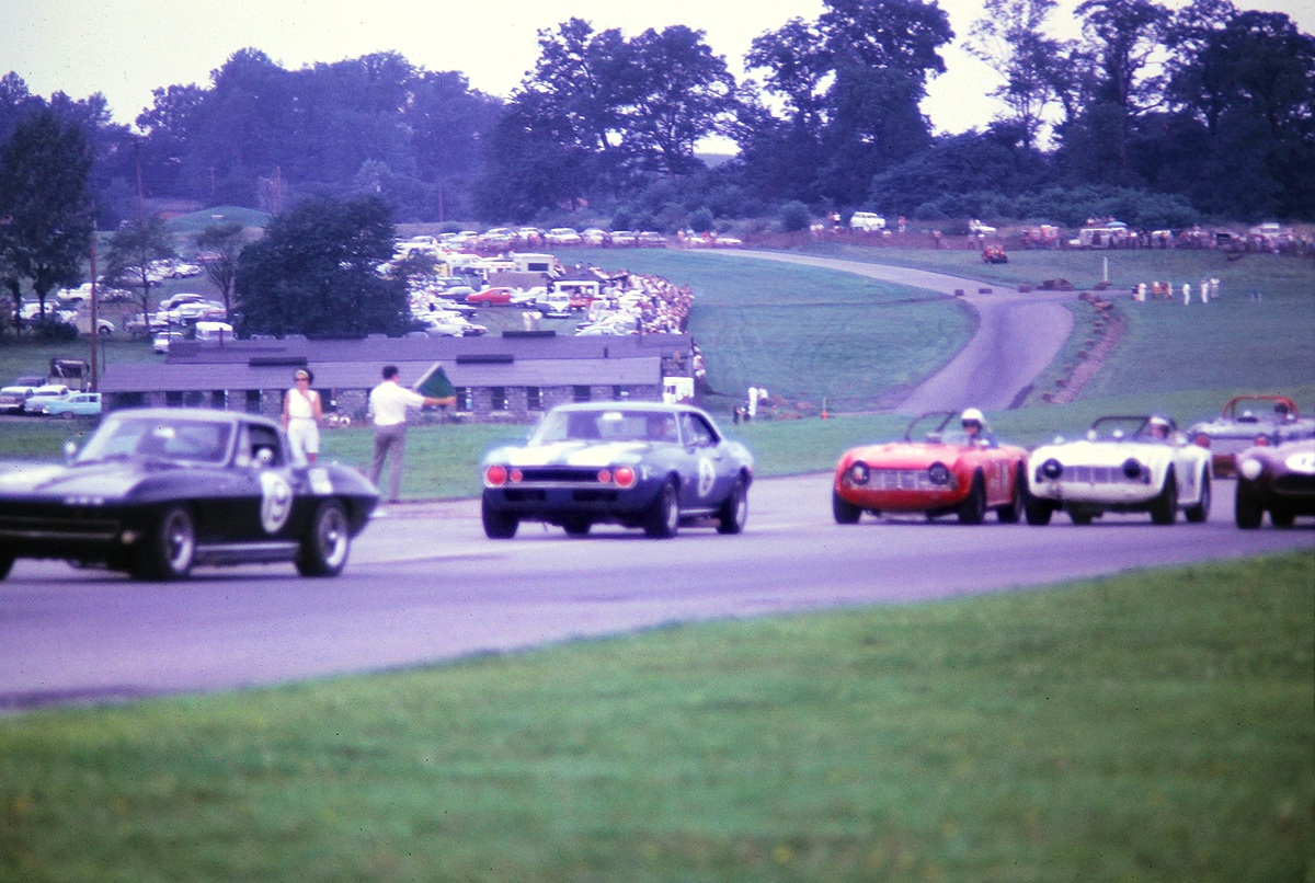Ralph Schubel’s Stingray is about to get eaten by Steve Elfenbein’s Camaro. DP winner Keith Kendig (white TR-4) is behind.