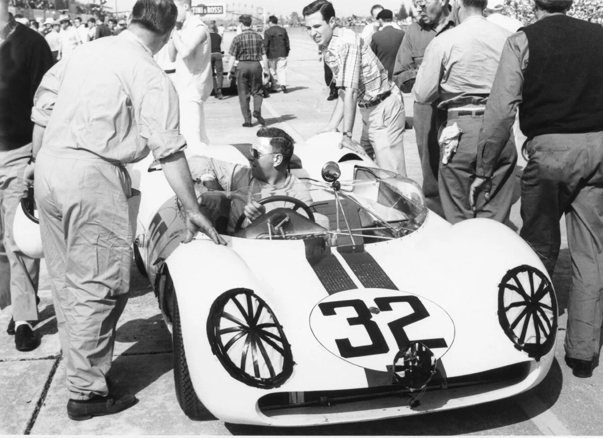 Walt Hansgen gets pushed to his starting position in the rear engined Tipo 64 Maserati. The car was doomed from the beginning. The front suspension broke in practice and the rear failed and put the car out of the race after only 30 laps/.