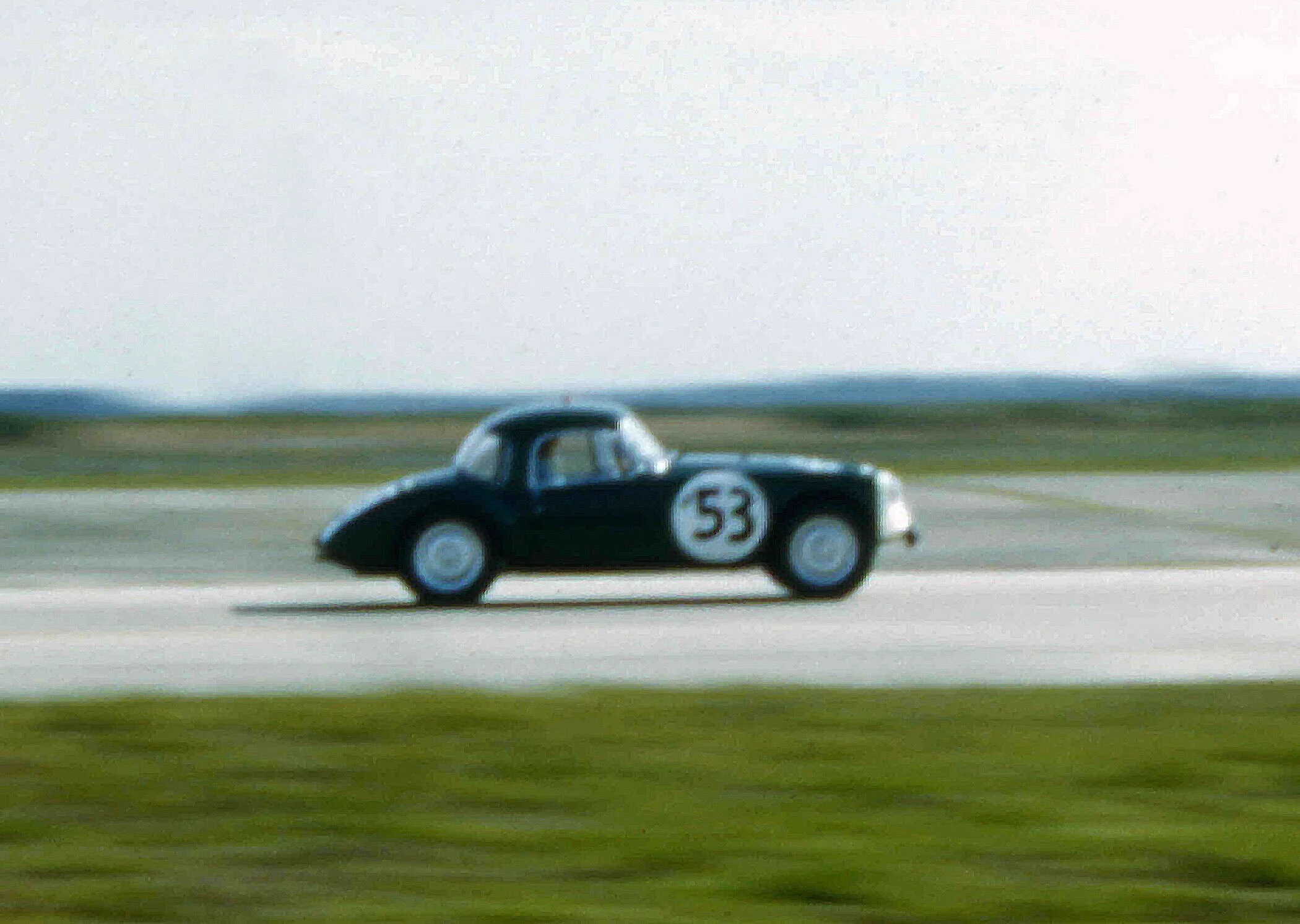 A fuzzy shot of 53 on the back straight. Bob Oltoff and Sir John Whitmore finished 20th overall and 2 laps behind the other MGA’s.