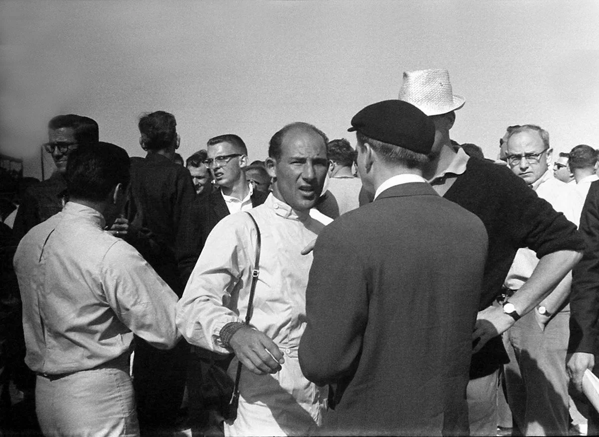 Moss next to Jo Bonnier (white hat) and Pedro Rodriguez (drivers suit). He was always making deals even on the starting grid.