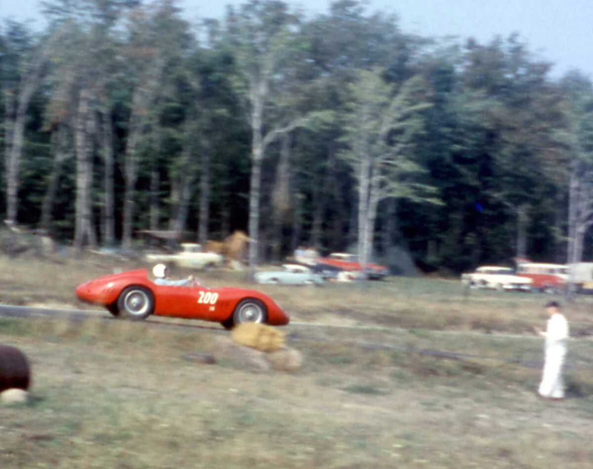 Arch Means signals as he enters pit lane in the 200S Maserati.