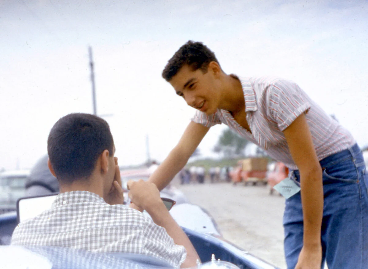 Butch Hollenbeck asks Nicholas “how was it”. Dave still sits in the car.