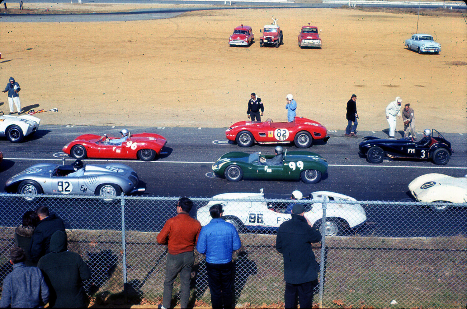 The middle grid has Skip Scott’s Elva next to George Wintersteen’s #92 RS-60 Porsche. Tom O’Brien’s Ferrari Dino is next to Peter Goetz’s Elva MkVII and Steve Quicley’s Rev-master special #86. Mike Goth’s black Lotus 7 looks a bit out of place.