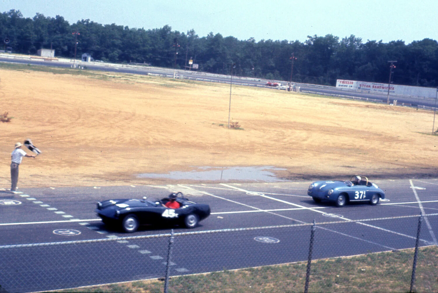 Peter Claydon in the black Courier leads Lake Underwoods Porsche across the line. Both these drivers were quick and this probably was for the win.