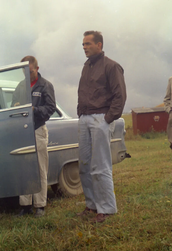 Phil Hill, hands in pocket is wondering why he left sunny California. Friend, driver and mechanic Richie Ginther stands next to their weekend car. NO, there weren’t any smart phones in 1958 so he is not checking Facebook.