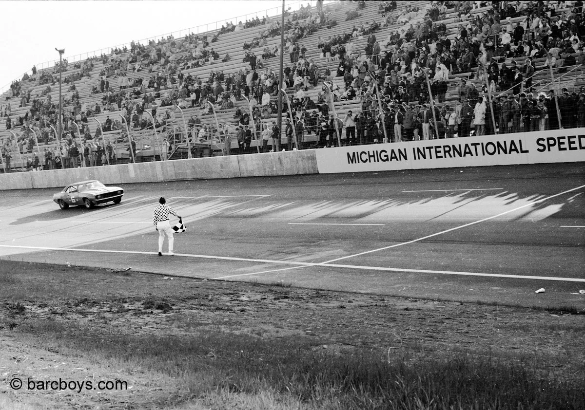  Mark Donohue finishes 2nd and gets the checker.  Not much of a crowd for this first road race.  It was cold and rainy most of the day. 