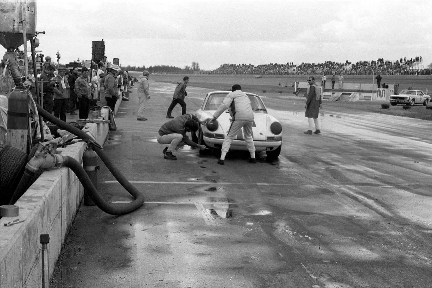  Peter Gregg in the pits for fuel and a glance at tire wear.  Usually very reliable, the Brumos team did not finish the race. 