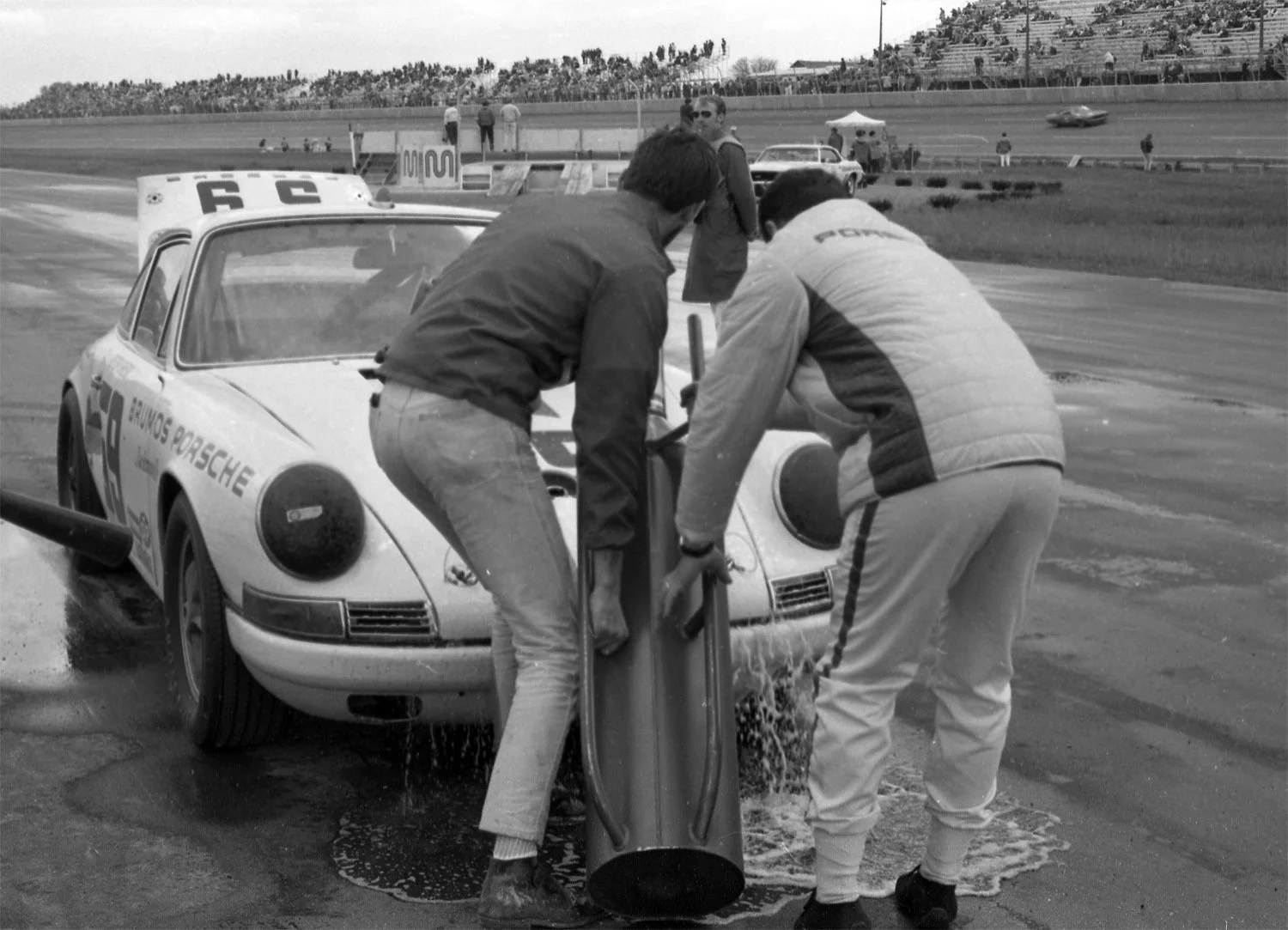  The crew takes down the refueling can.  This was bigger than the usual 10 gallon can and required two men to lift and pour. 