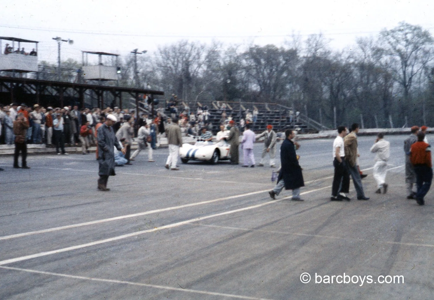  The day is finished and Don Sessler takes the applause of the crowd as they leave the grandstand.  Take note of starter Tex Hopkins in his lavender suit.  The road course was mostly financed by local DC racers who named themselves the Lavender Hill 