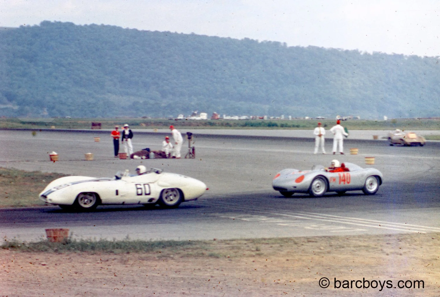  This was the battle of the day.  Once Bob Holbert got clear of traffic he drove his RSK up to the back of Hansgen’s Lister.  But the cagey Jag driver knew he could use the acceleration of the big Jag motor to hold off the Porsche and this is how the