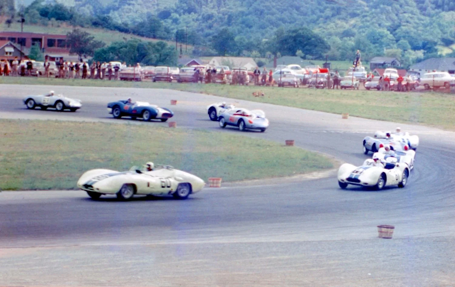  The race has started and Walt Hansgen takes the lead in the Costin followed by Freddy Windridge in #61 then Bill Sadler, Roger Penske, Don Sessler and a fast charging Bob Holbert in the silver RSK with red numbers 