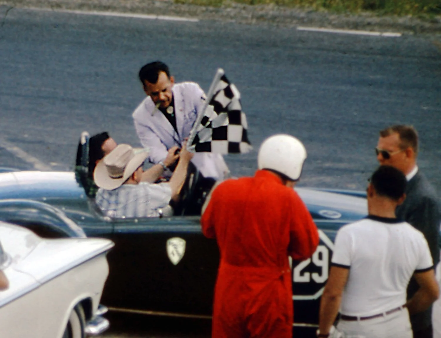  Tex Hopkins, always present cigar in his mouth, presents the winners flag to Bucher, which Spankey Smith quickly grabs before heading out on the victory lap. 