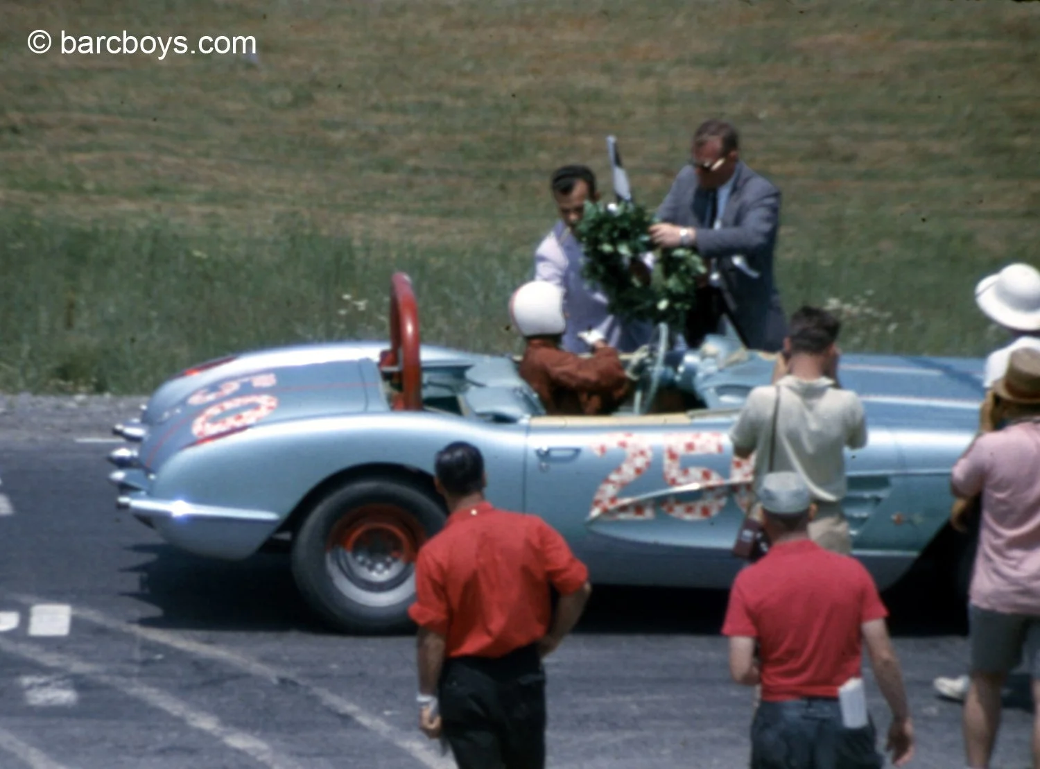  Harold Keck has won and gets his checkered flag and huge wreath.  Hal was a fun guy and somehow convinced the rather stodgy timers to allow him polka dot numbers. 