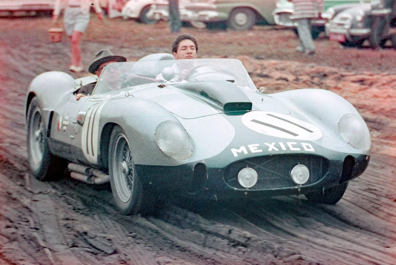  1959: It was a cold and rainy weekend.  Pedro Rodriguez drives through the mud with is father in the Ferrari 250TR #11.  Pedro co drove with Paul O’Shea but as was usual for the Rodriguez boys, the car failed to finish. 