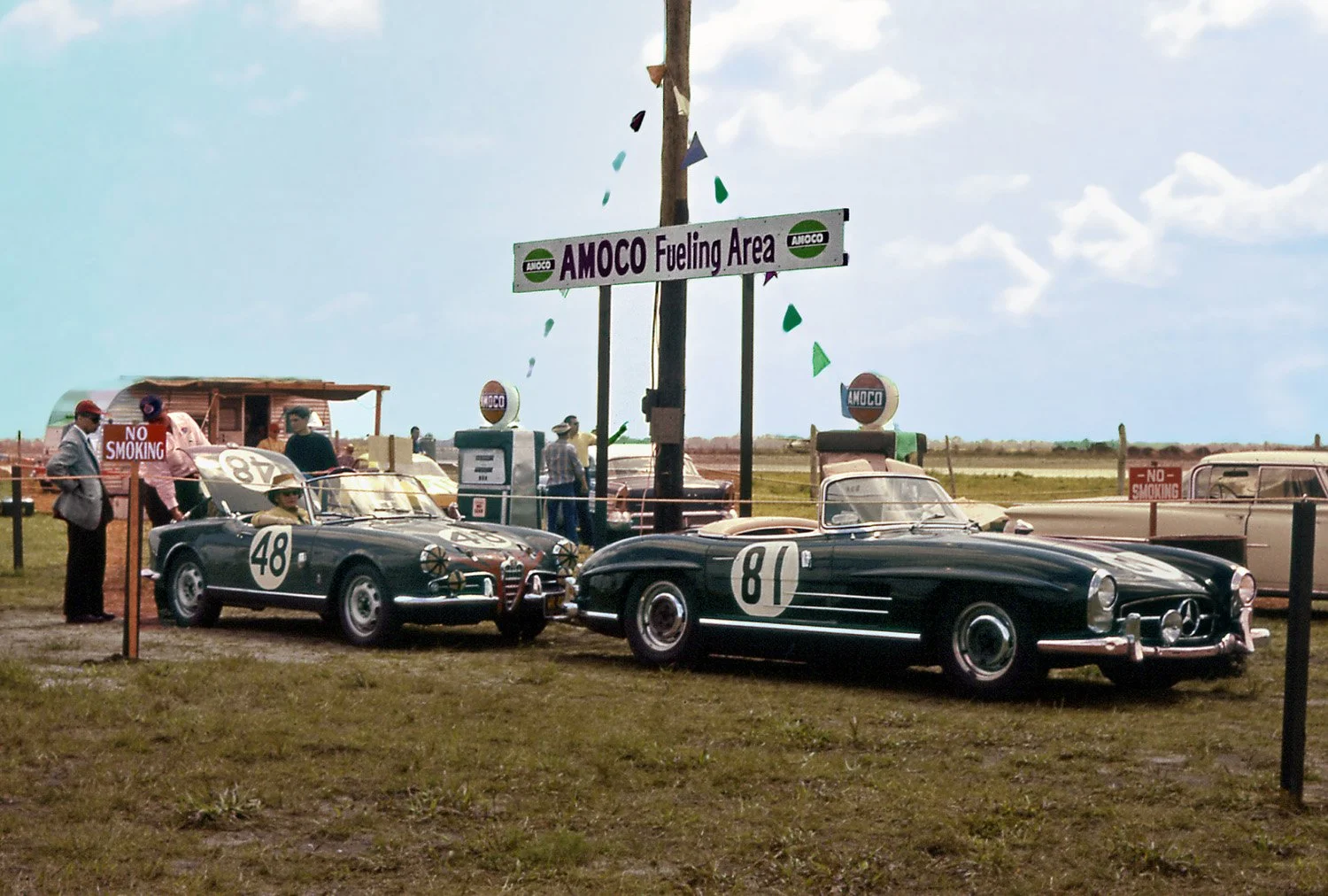  1960: Cameron Argetsinger (red cap) watches as his Alfa is fueled before practice.  This fueling station was busy all weekend with teams taking 5 gallon cans back and forth during the race.   