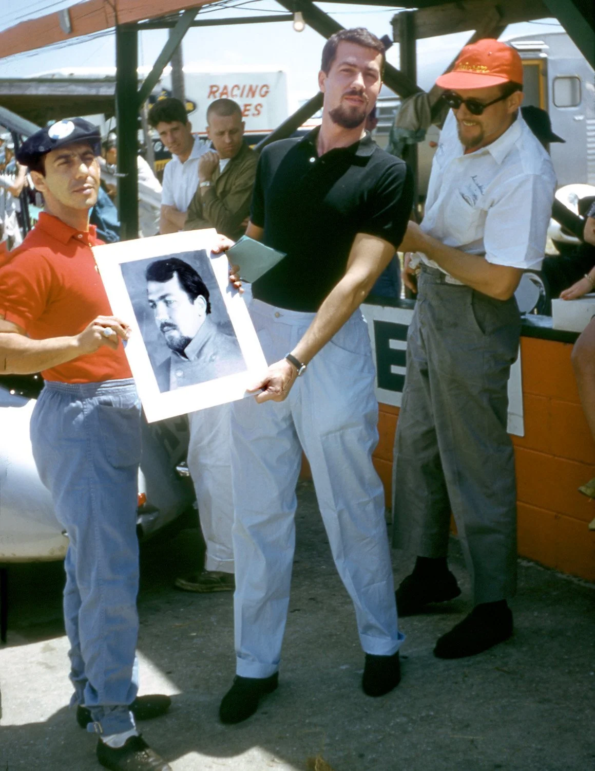  1960:  Jo Bonnier and Johnny Cuevas hold a drawing of Bonnier.  No idea who did the artwork or why Johnny was holding it.  Cuevas was famous for his lighter collection and later his ink pen collections.  Did he draw this portrait? 