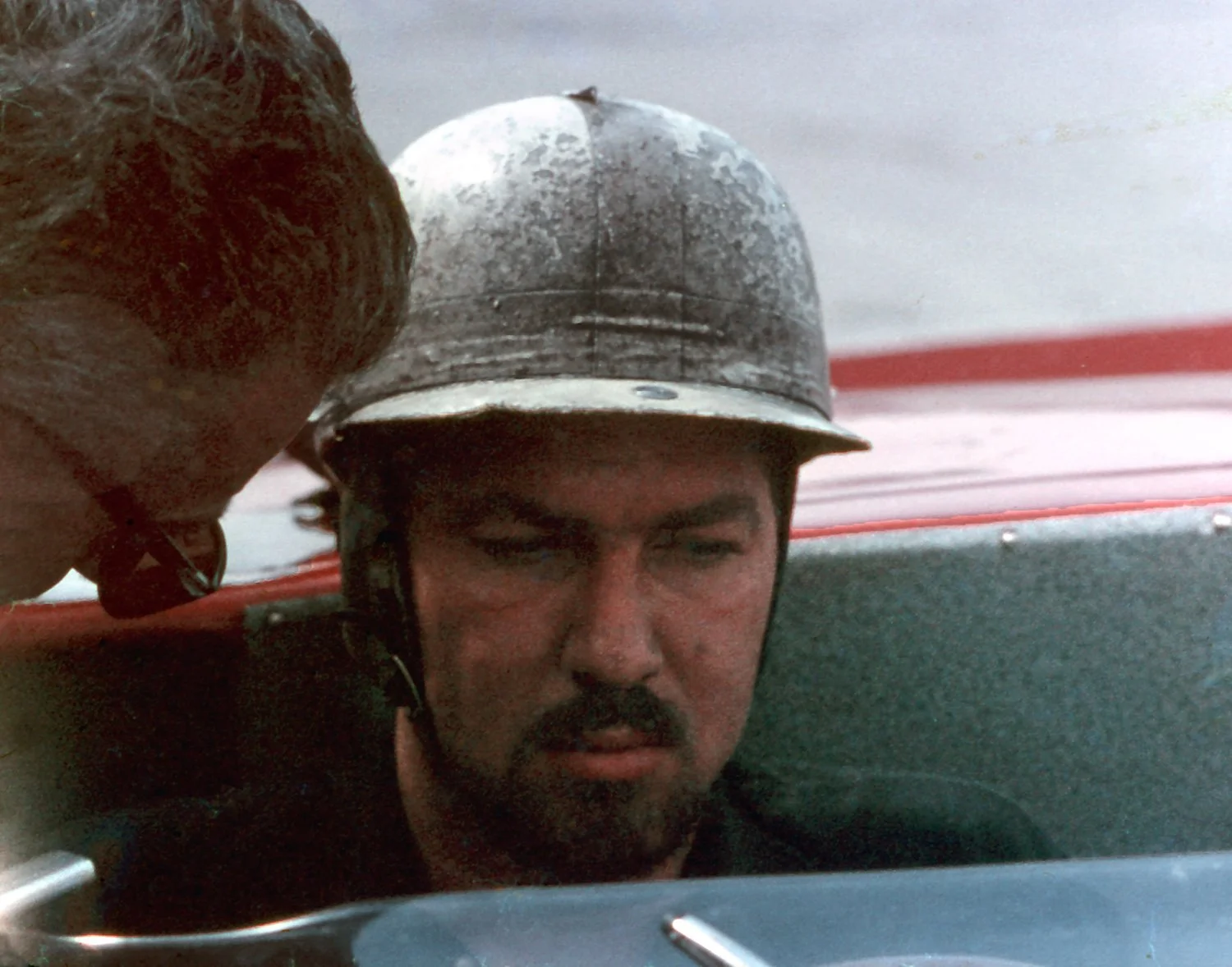 1962:  Jo Bonnier discusses something in the cockpit of his Serenissima Ferrari TRI/61 during practice.  A great year for the Swede as he won overall.  From a Swedish publishing family, Bonnier was easily the most sophisticated GP driver. 