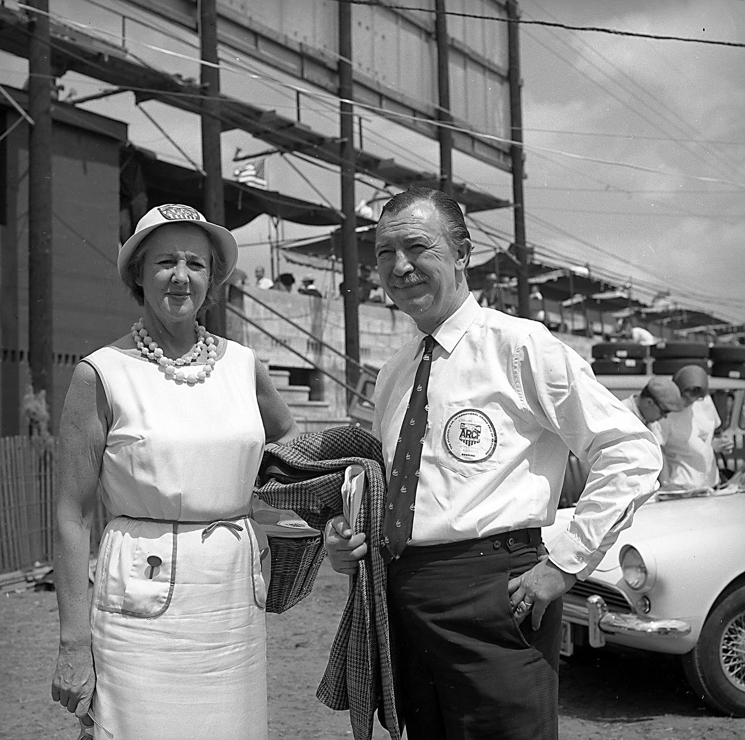  1962:  Mrs. Alec Ulman poses with publisher Gregor Grant.  Grant was an annual visitor to Sebring as the head of the huge British journal “Autosport”. 