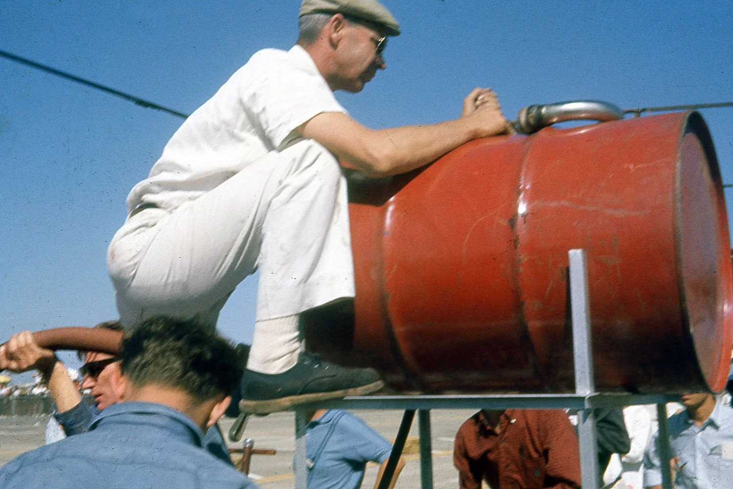  1963:  Crews are preparing an overhead refueling system.  By now crews had figured out it was much faster to use a huge tank and gravity to refuel.  It took several years before they figured out how to stop the gas from gushing out when over filled.
