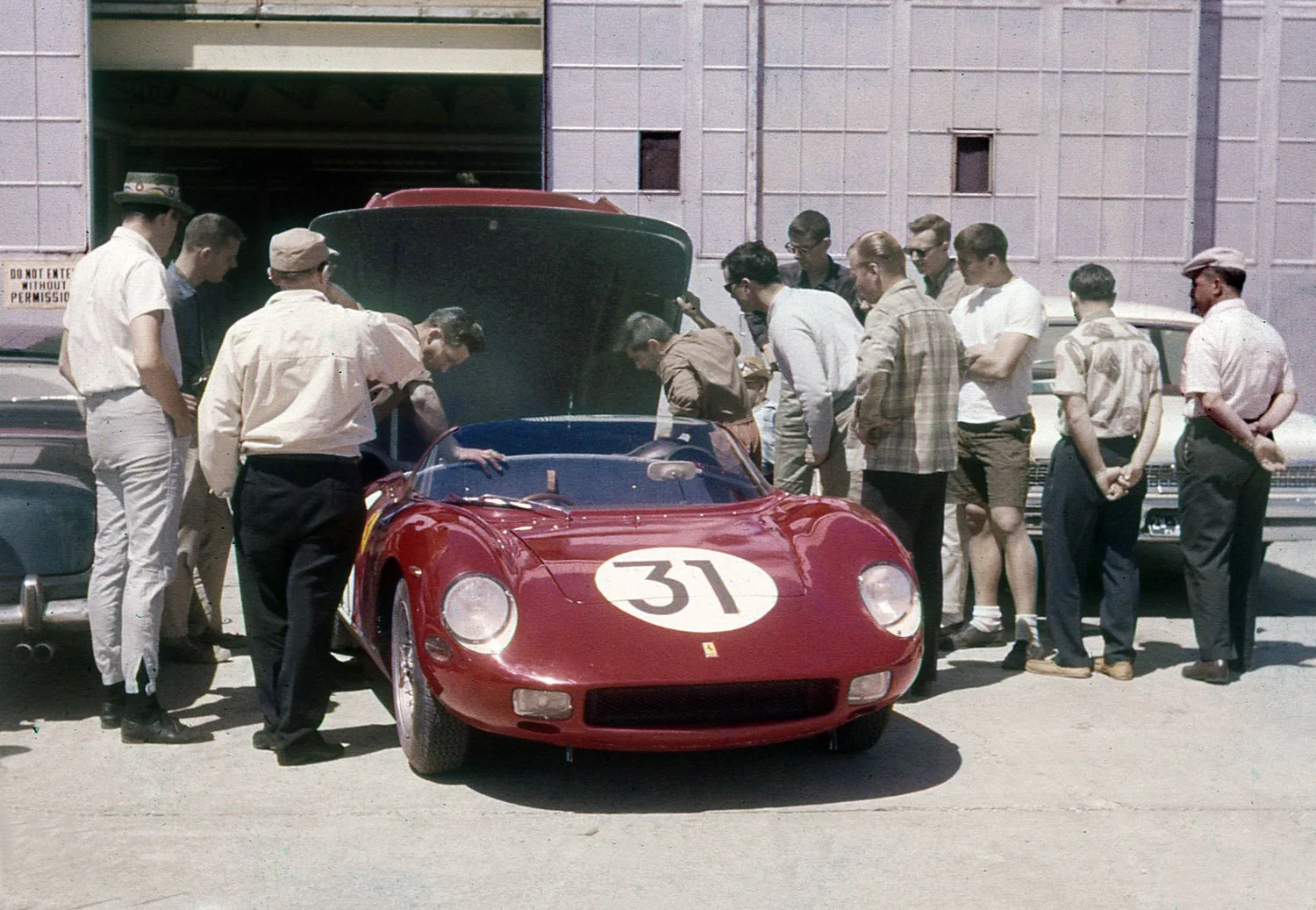  1963:  There was always a crowd around the prototypes and this gathering is looking at the business end of the Mairesse, Vacarella and Bandini 250P Ferrari.   