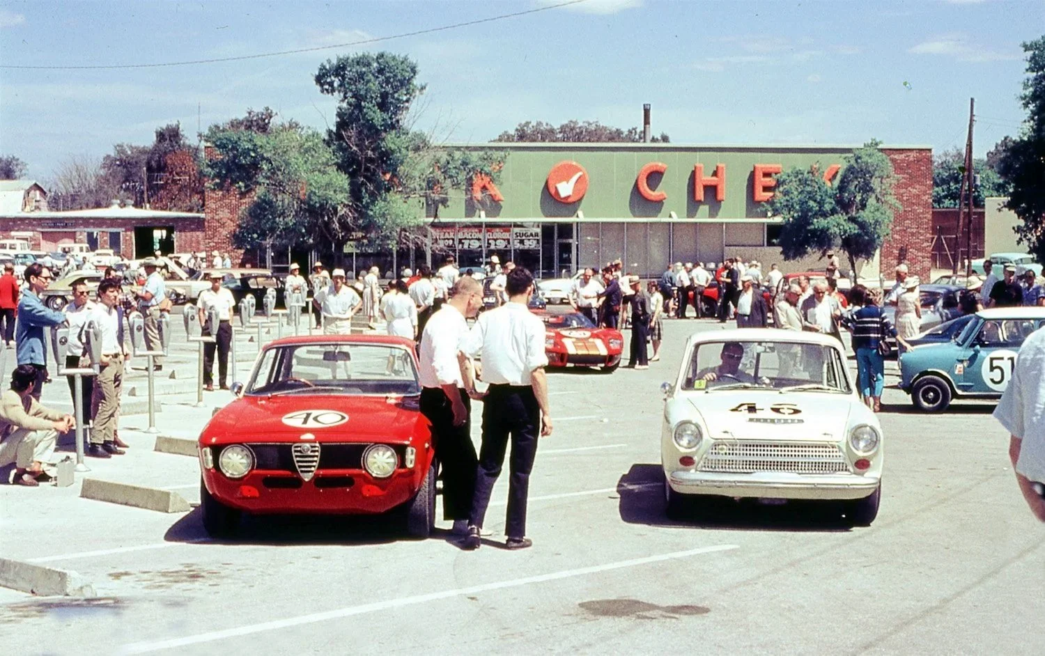  1966: Tech inspection was still held in town and was always a fun time for locals and race crews.  At this time everything from a Mini to a Ford GT to a couple U2.5 sedans are waiting. 