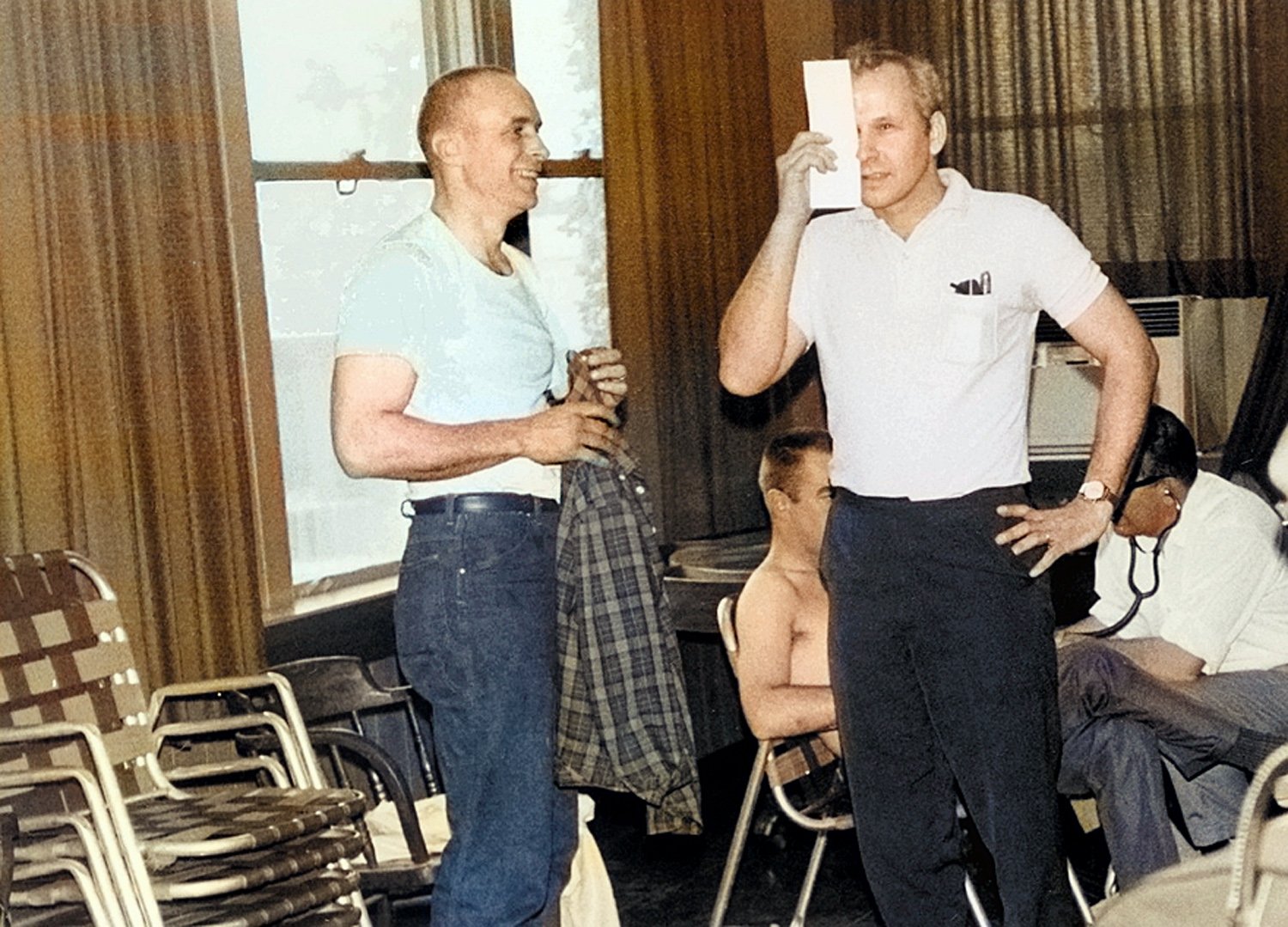  1965:  The FIA required checkups on drivers.  Oscar Koveleski is reading an eye chart while Sherm Decker laughs.  Oscar, no doubt, is telling the doctor that he can only read Polish. 