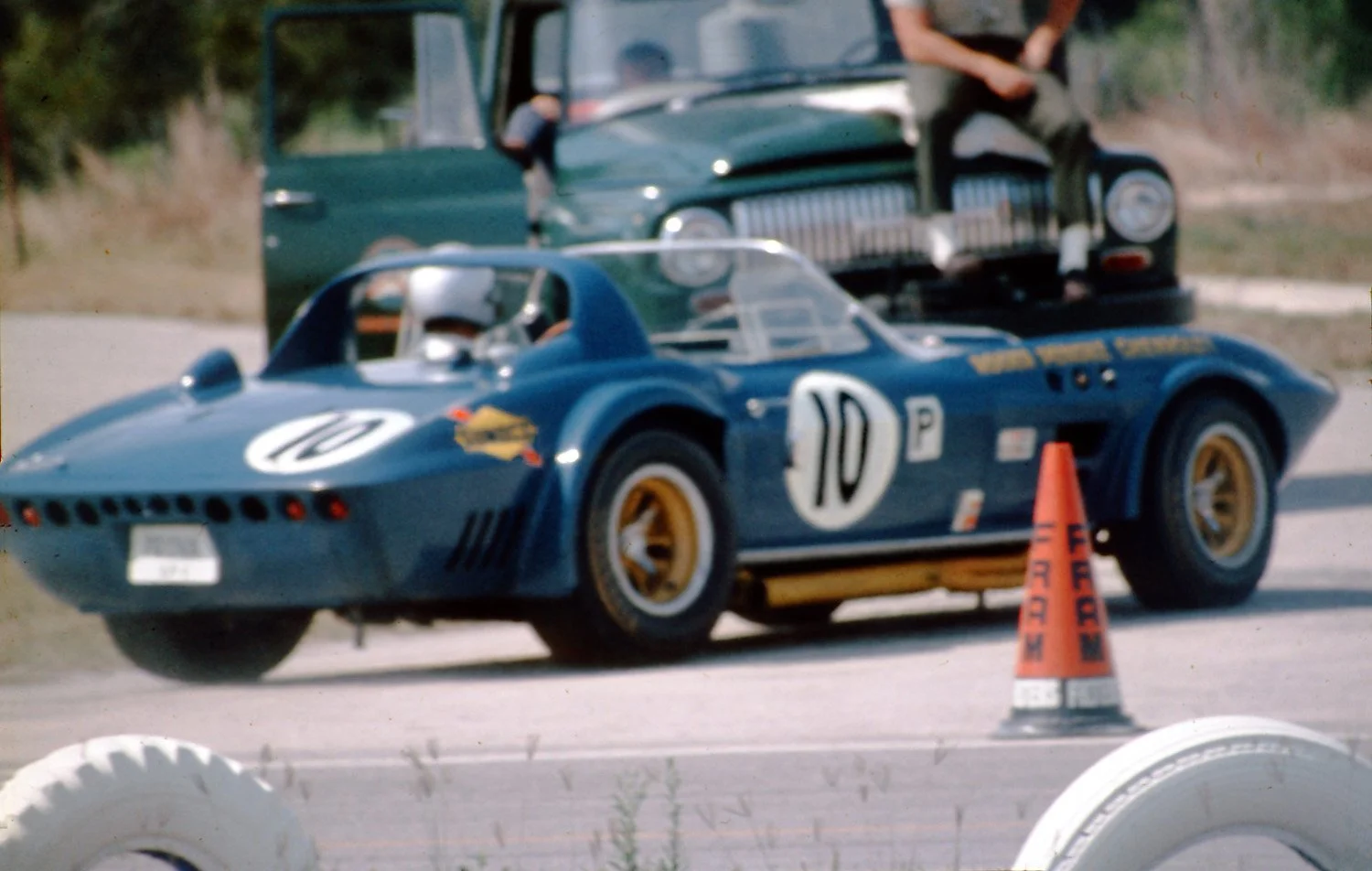  1966:  Despite being a big overweight, the Penske Grand Sport was doing well with Dick Thompson and Dick Guildstrand driving.  Lapping a slower car the Vette went off and suffered terminal suspension damage.  The tow truck waits. 