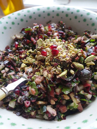 Top with chopped pistachios, the dressing and a few pomegranate seeds. This is one that keeps a few days and the leaves hold up well.