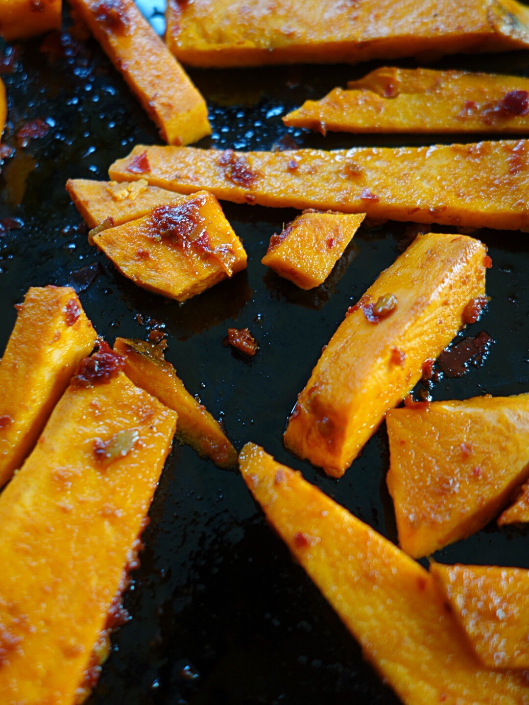 Rub a tbsp of rose harissa paste from Belazu plus a small glug of olive oil. Rub thoroughly all over the sweet potatoes and bake for 35 min at 175 c (350 F) flipping a few times.