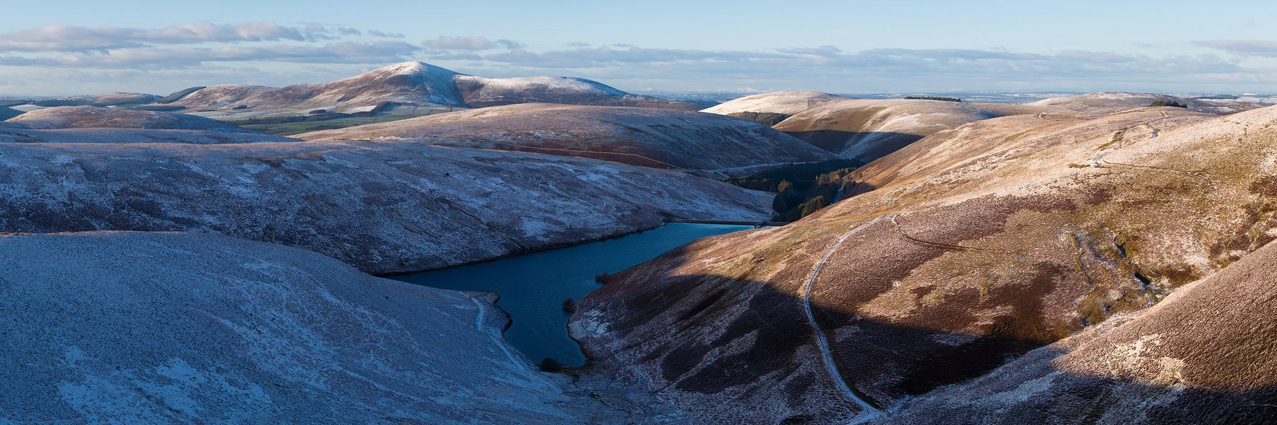 Cowgill Reservoir with Tinto Hill and the Clyde Valley beyond.