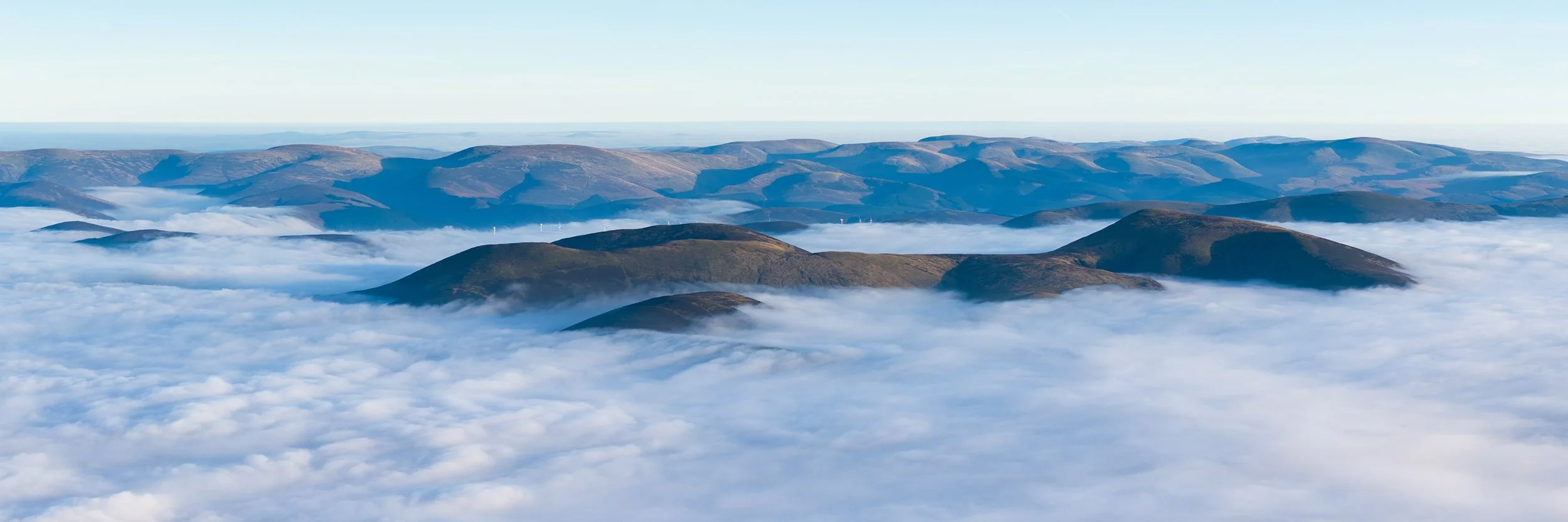 Culter Fell emerging from thick mist with the Tweed Valley behind.