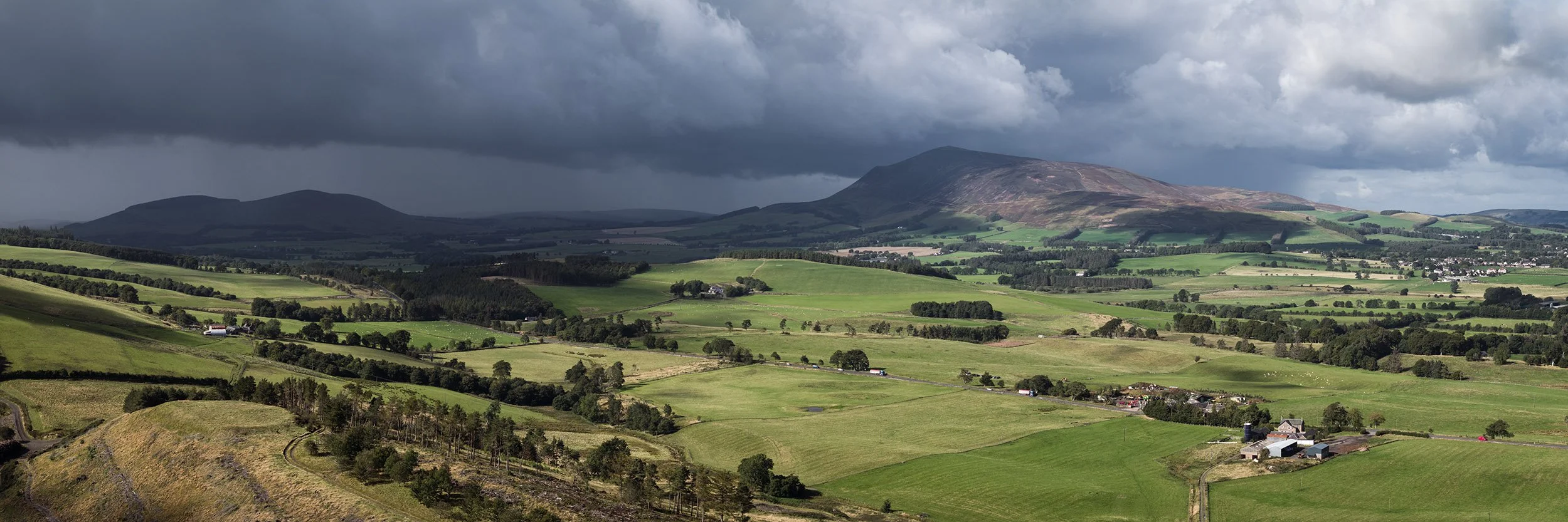 Upper Clyde Valley with heavy rain moving north over Tinto Hill.