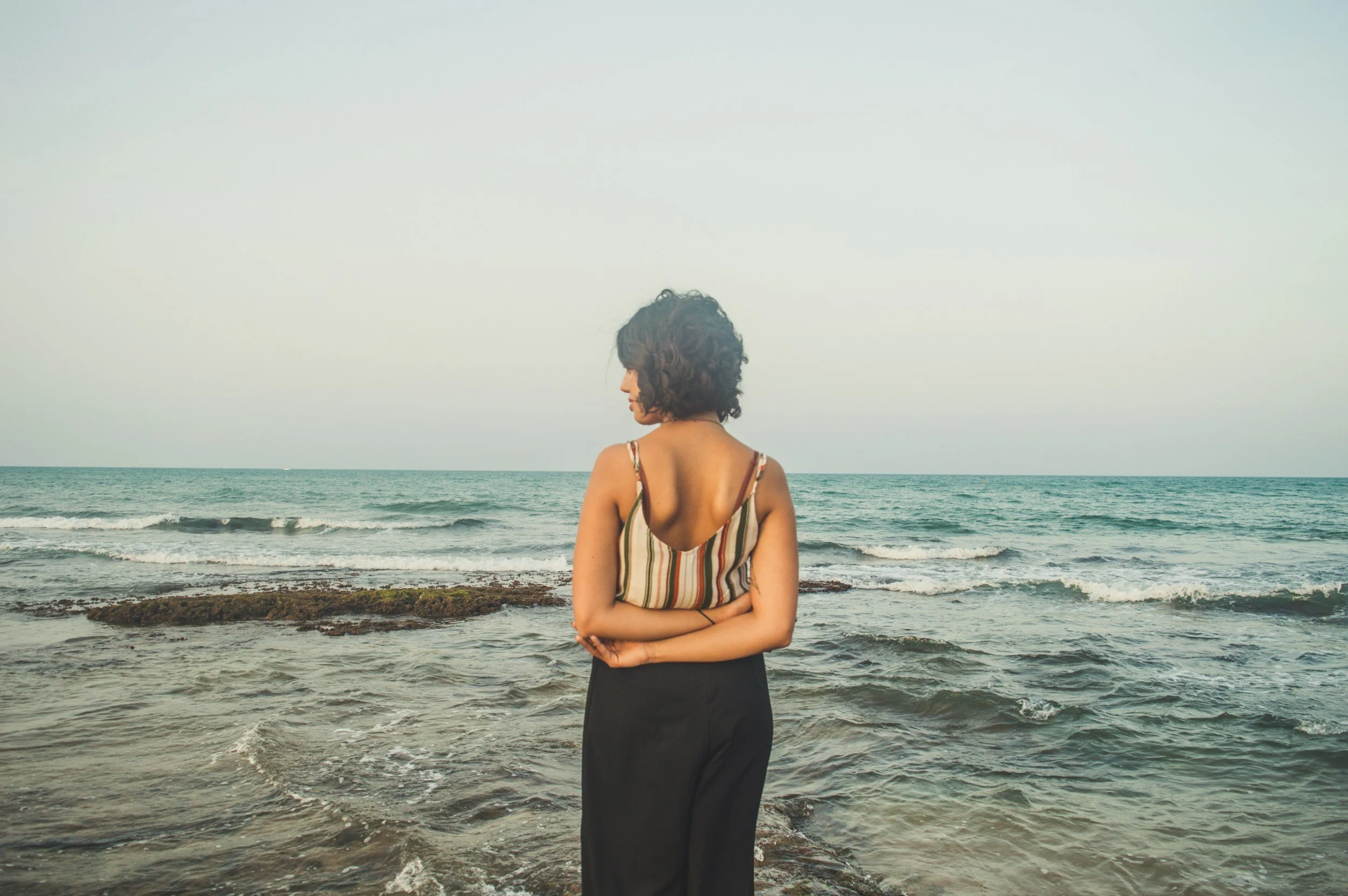 moody image of woman viewing ocean