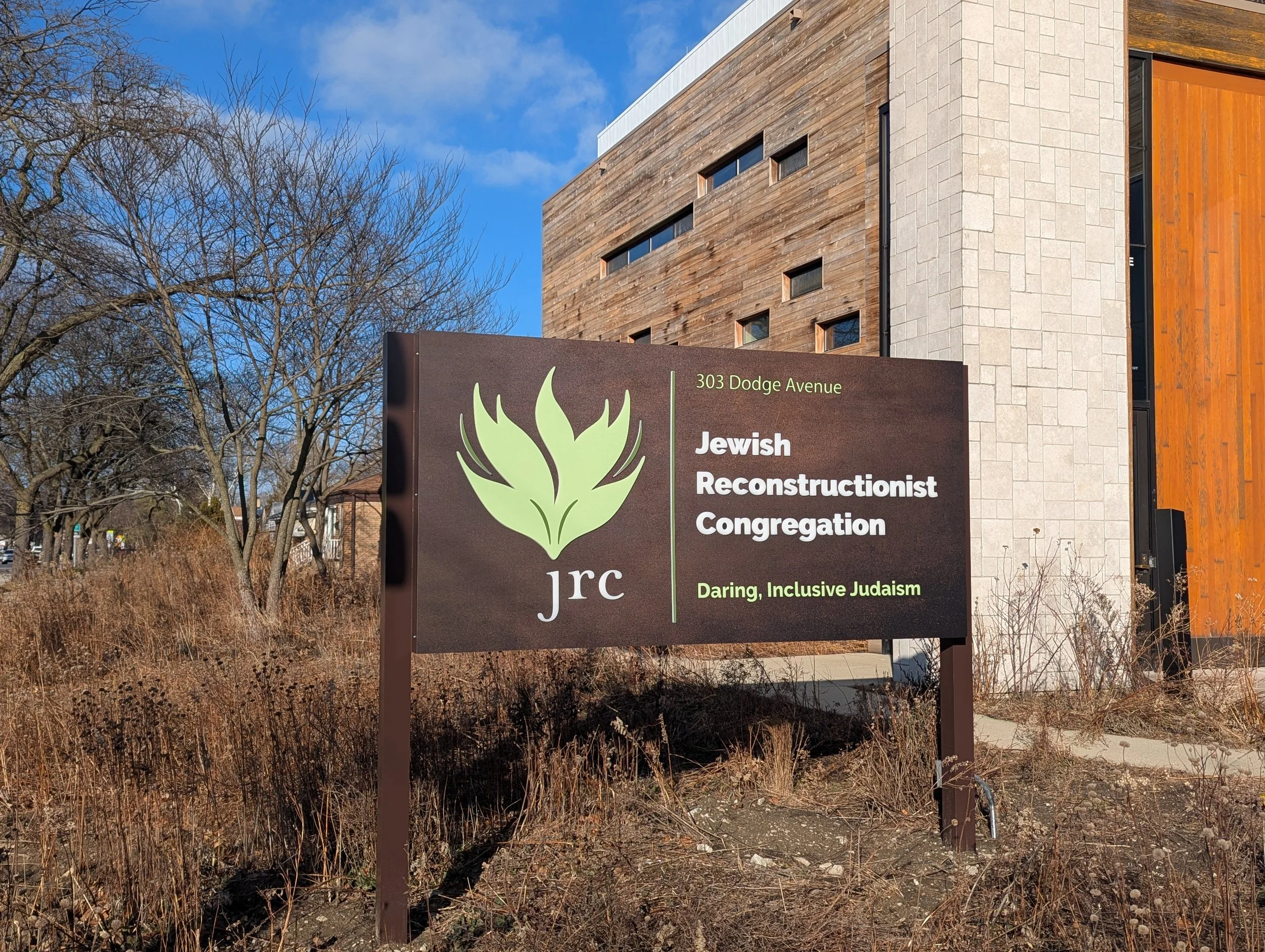  Jewish Reconstructionist Congregation wanted a simple sign that would integrate with their native plants garden and natural materials architecture. I chose a complimentary rubbed blackened steel surface for backlit dimensional letters and logo, and 