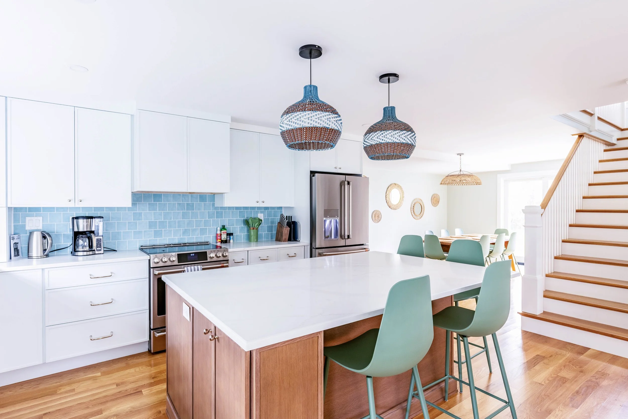 Modern kitchen with island seating and open layout connecting to adjacent living space