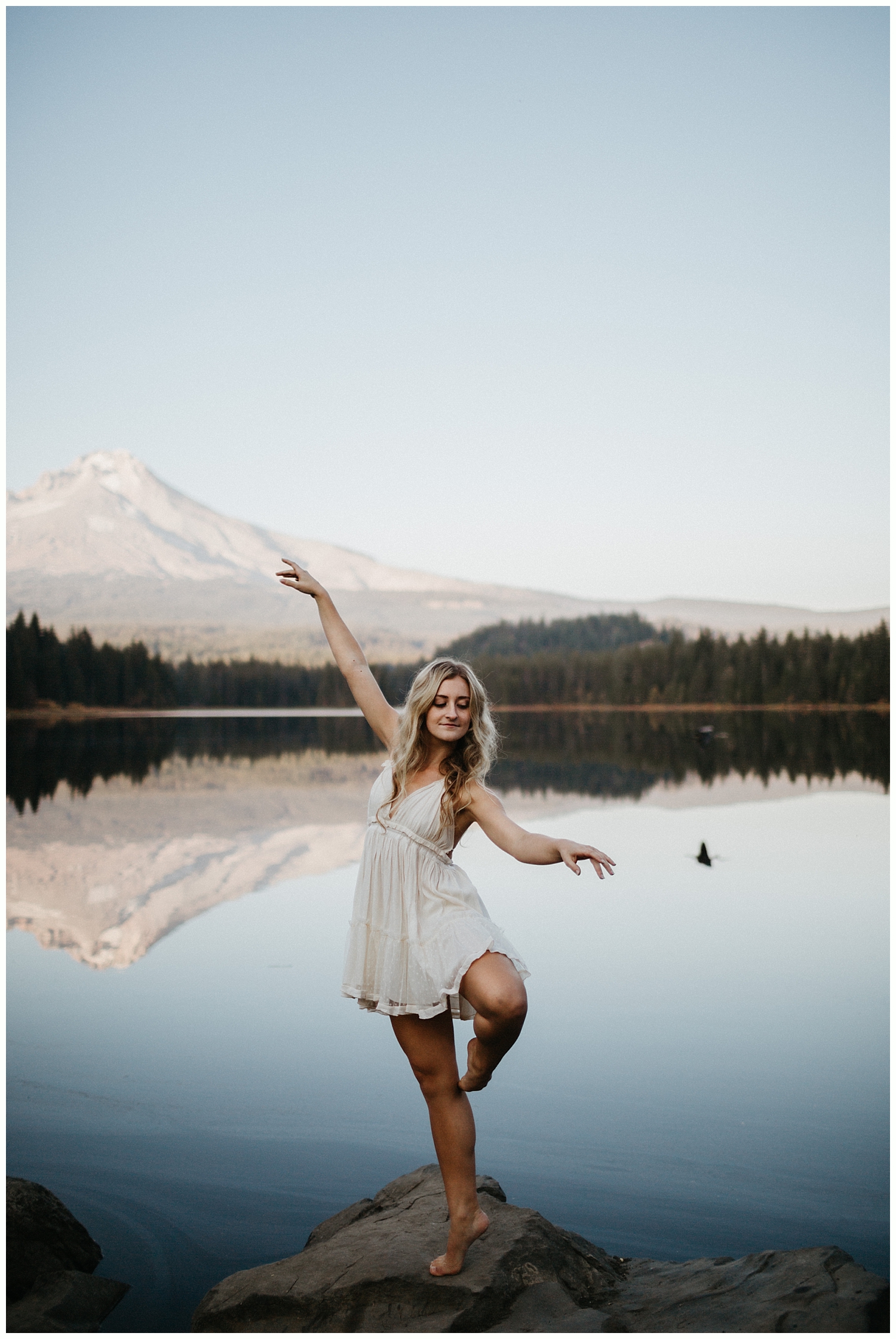  High school senior holding dance pose in front of Mt. Hood. 