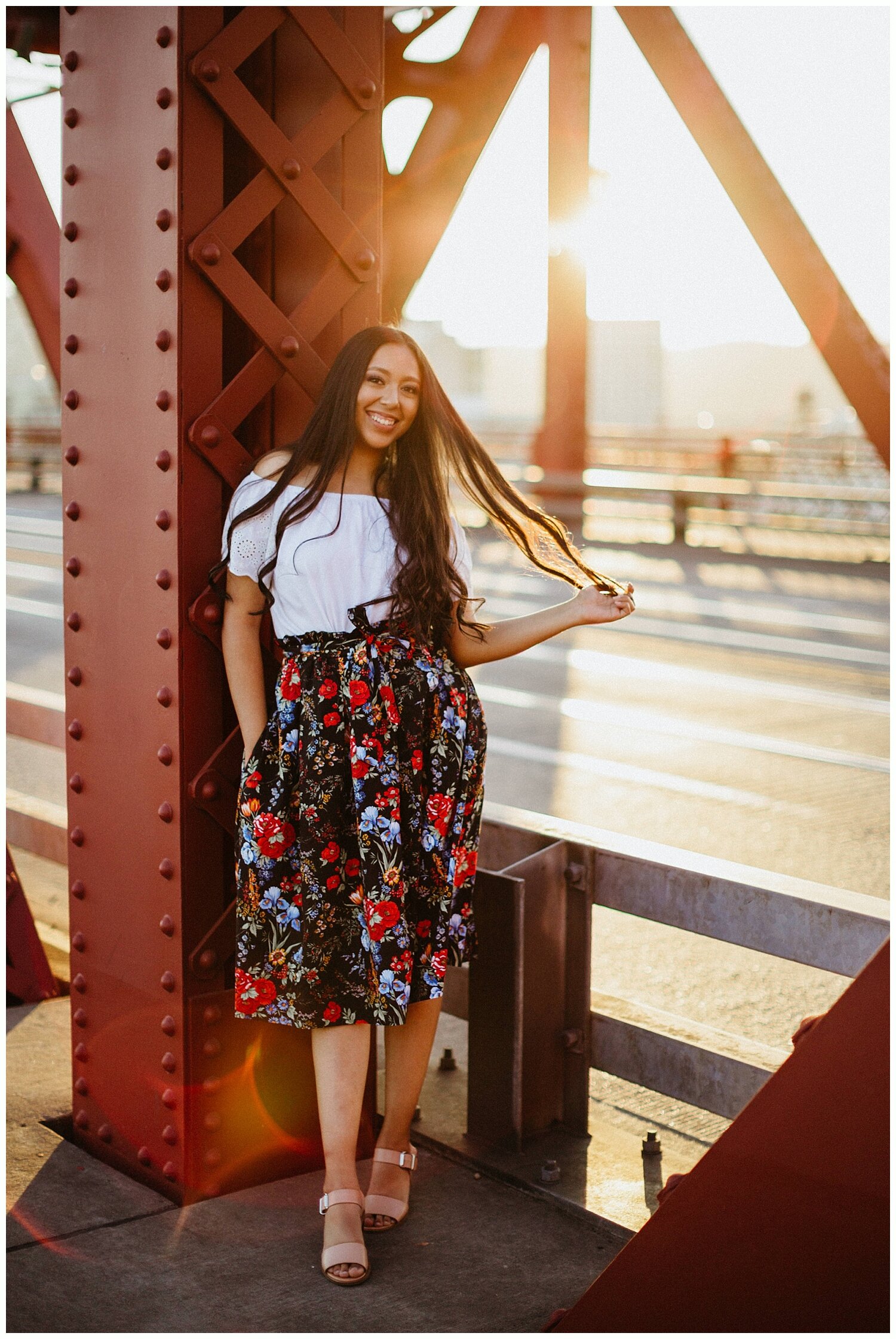  Backlit photo of high school senior on Broadway Bridge in Portland, Oregon. 