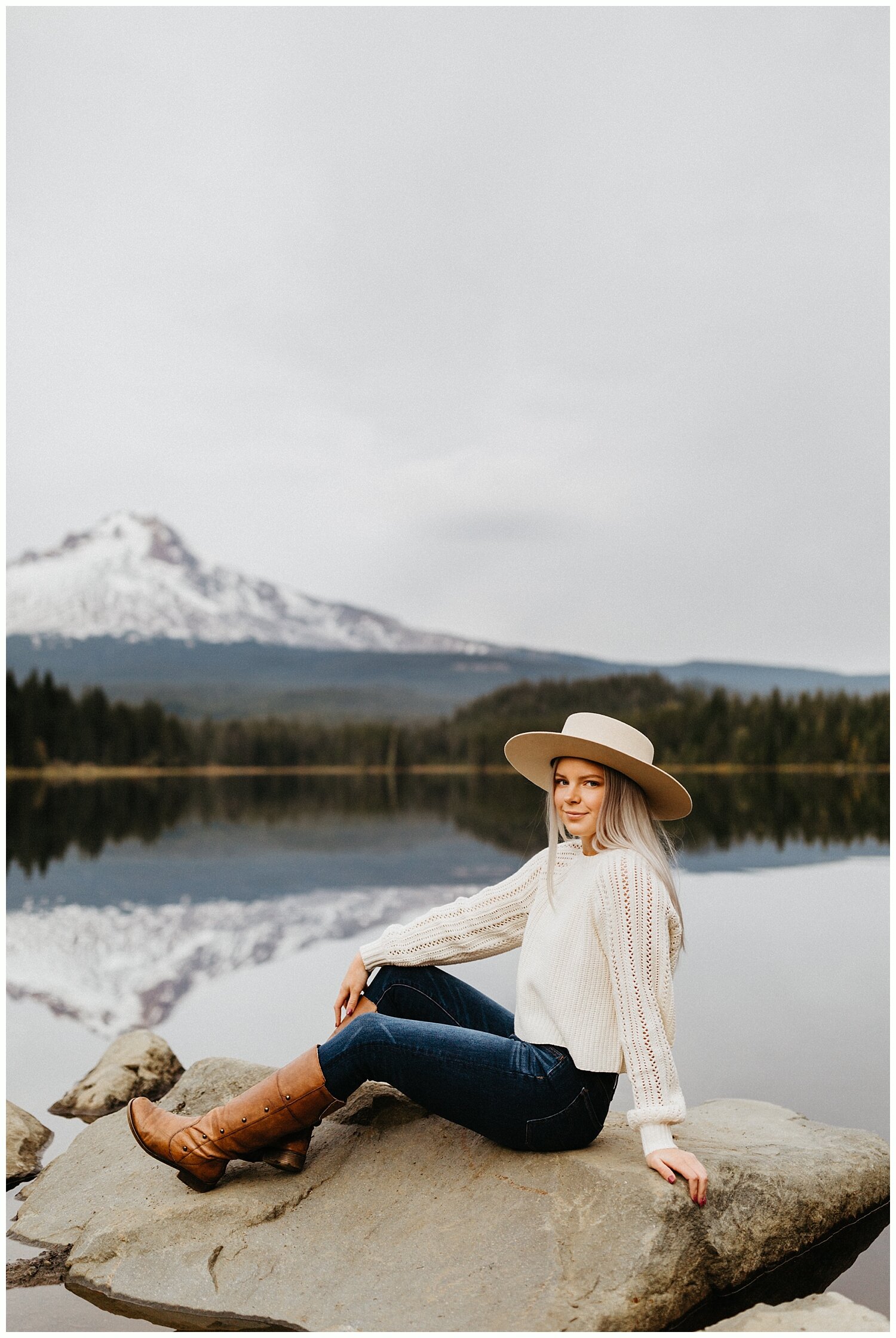  High school senior sitting on rock in front of Trillium Lake in Oregon. 