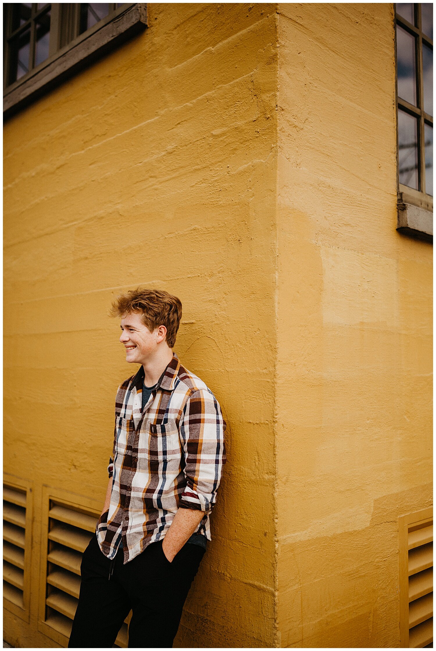  Red head guy smiling for his senior photos in Portland, Oregon. 