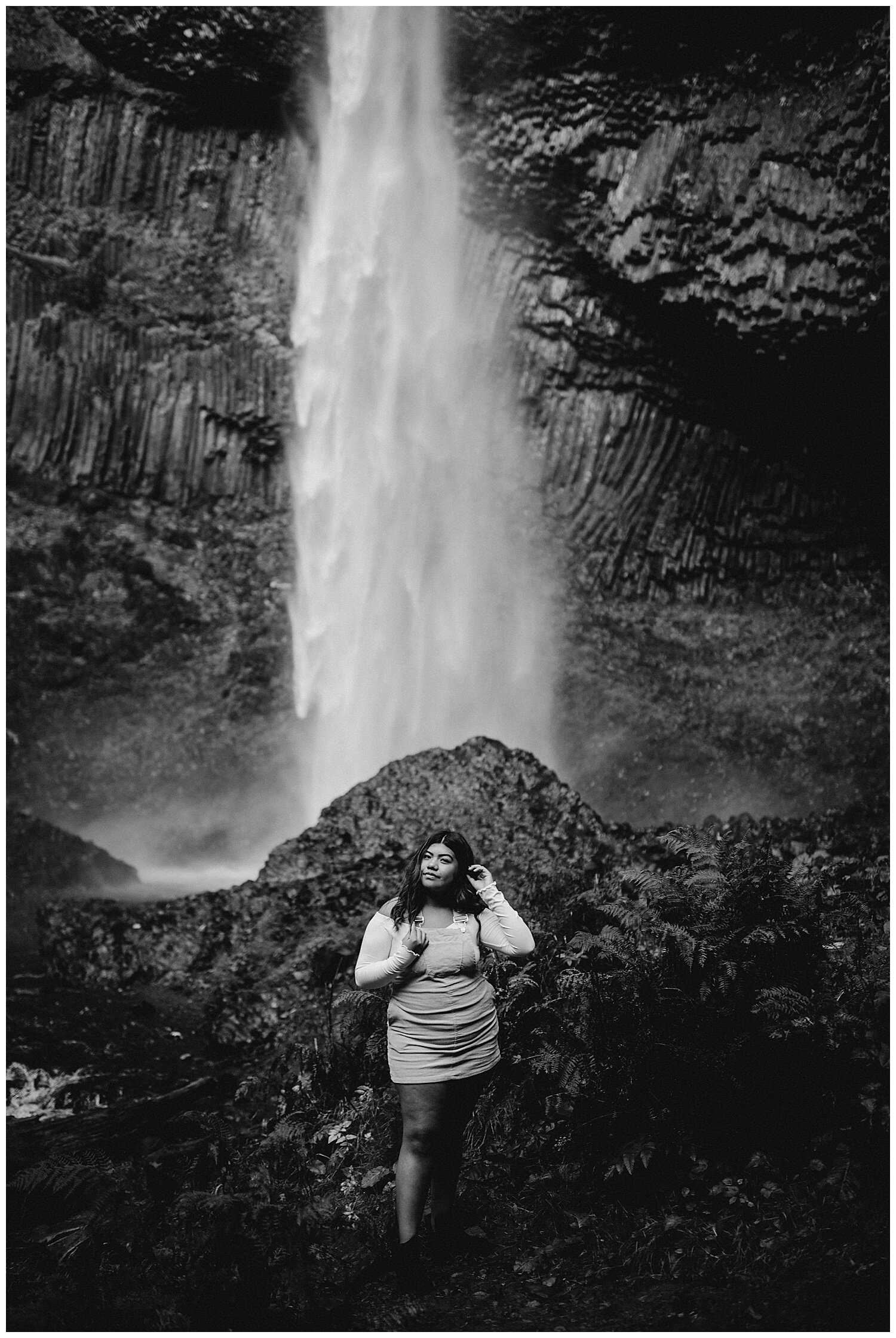  Black and white portrait of girl standing in front of Oregon waterfall. 