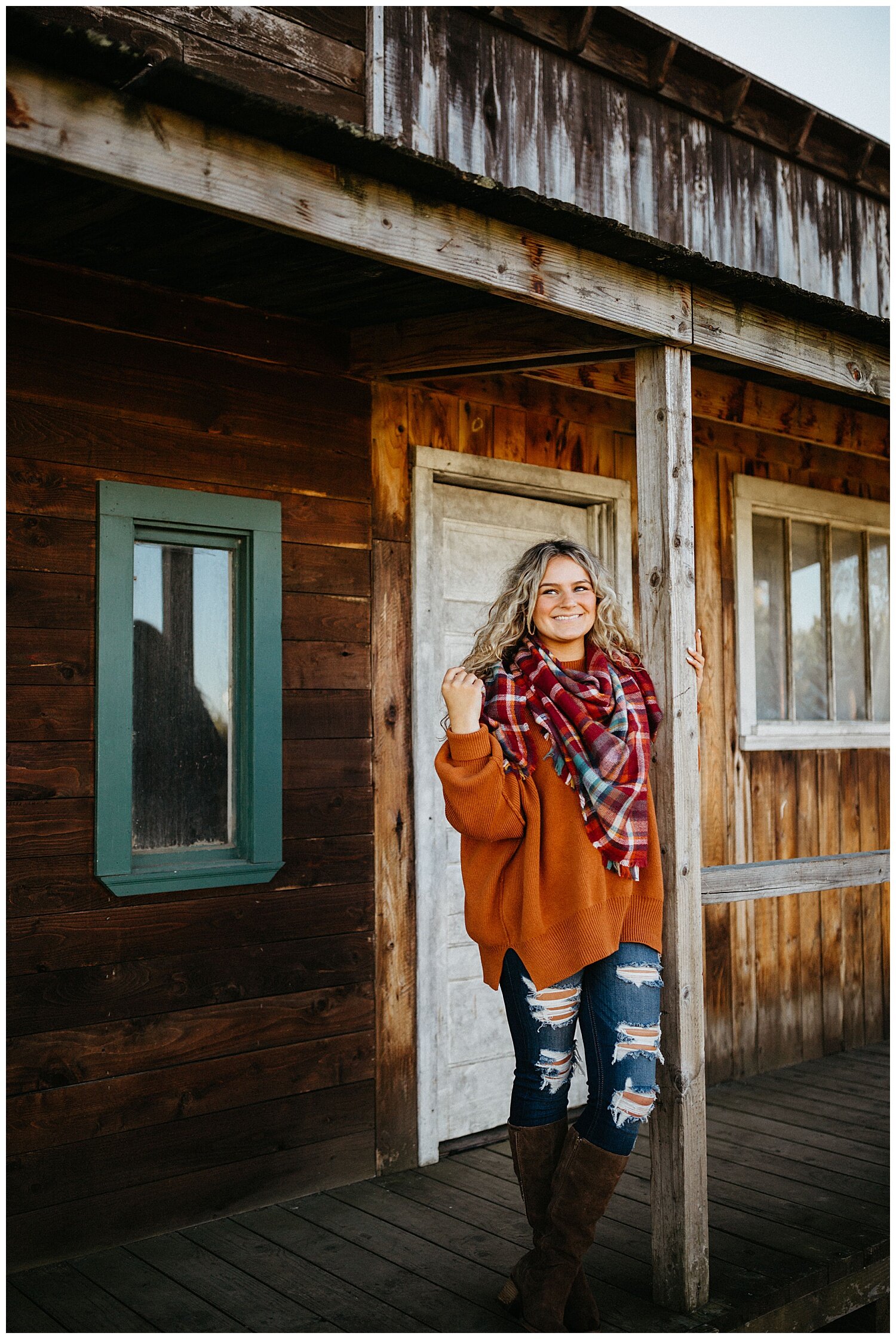  Girl wearing orange sweater and scarf for her fall senior photos. 