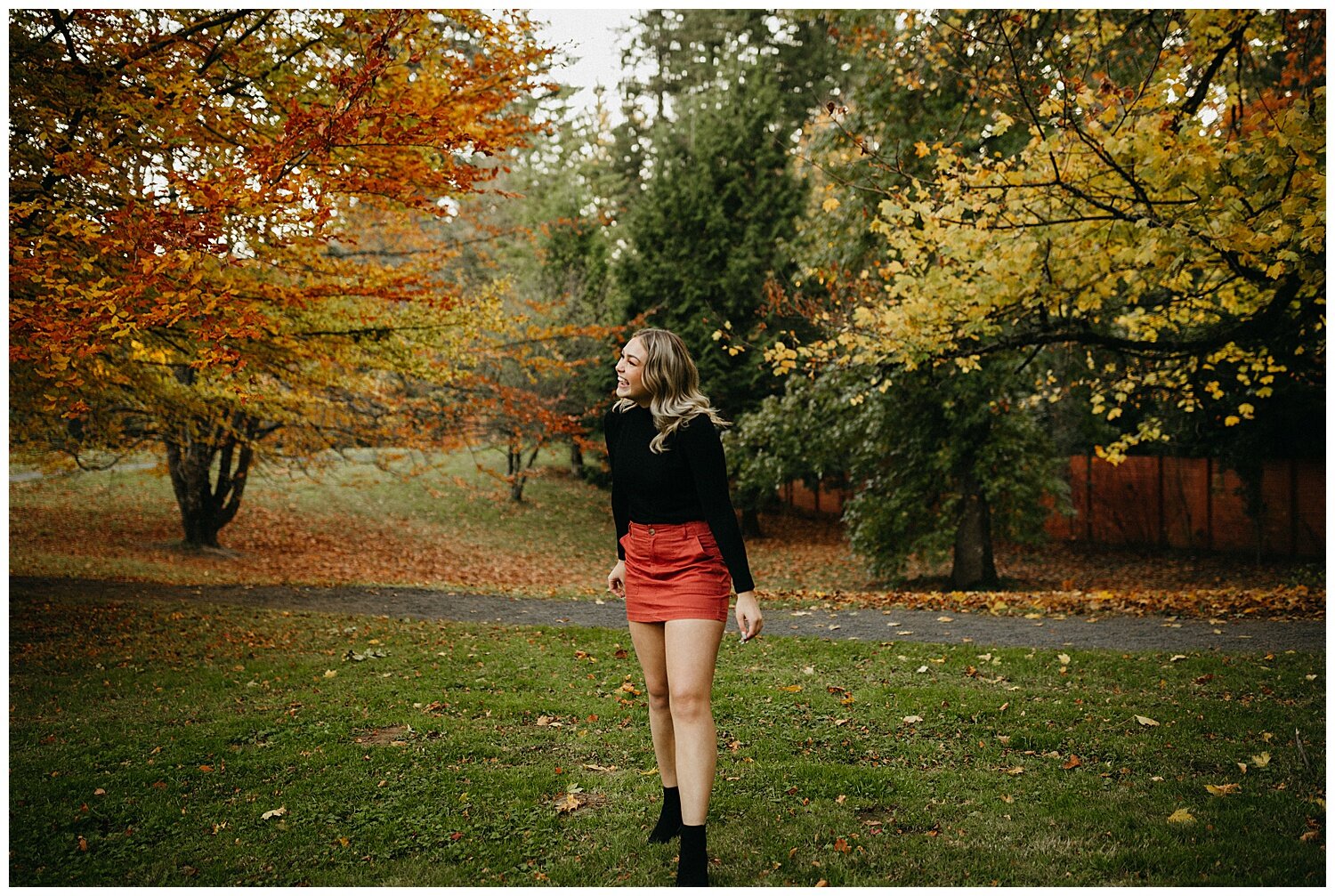  Girl walking next to fall trees in Portland, Oregon. 